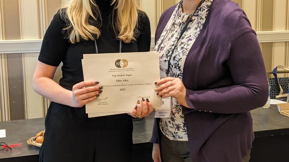 an award being collected by two people