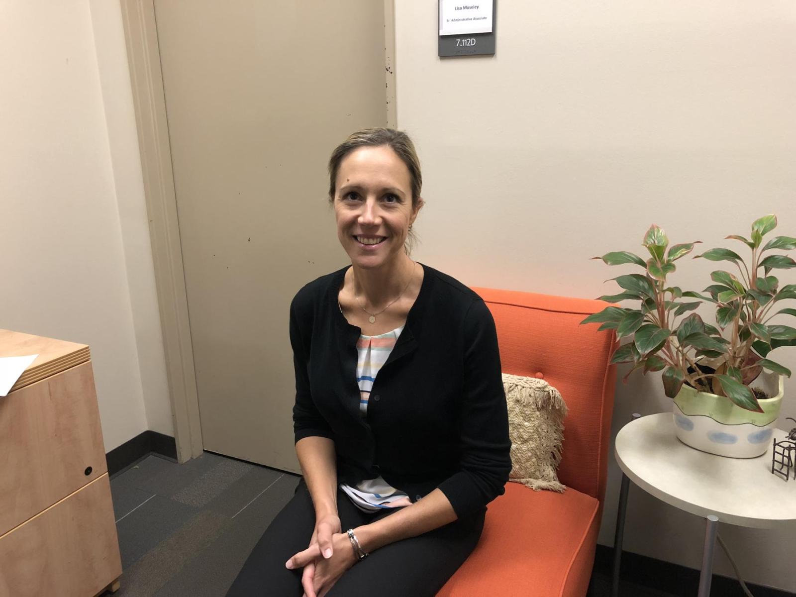 Dr. hartelius sitting in a chair smiling