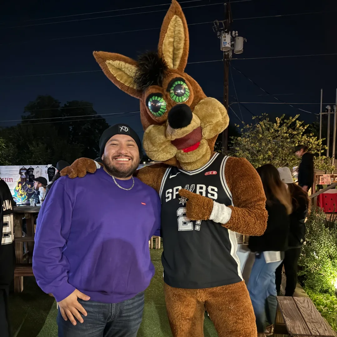 an image of Saul P at the spurs game with the spurs mascot