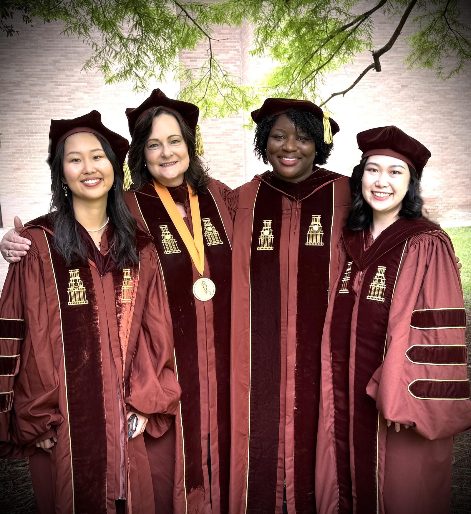 CMS Faculty and Doctoral students posing for photo.