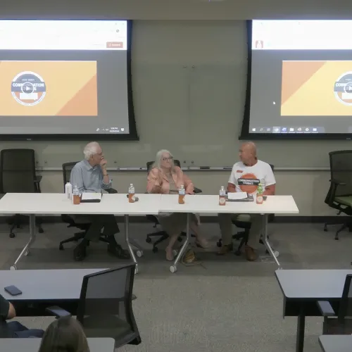 people sitting at tables on panel